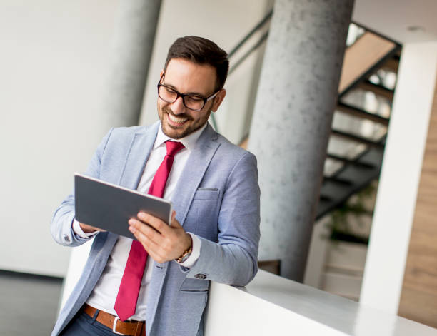 istock Young businessman with digital tablet in office 973301392