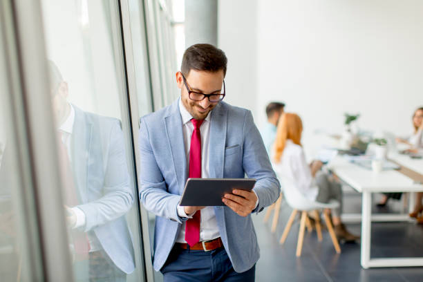 istock Young businessman with digital tablet in office 973301406