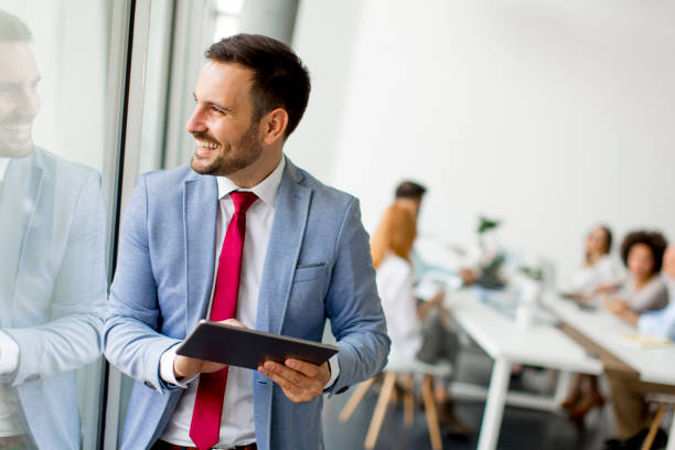 istock Young businessman with digital tablet in office 973301428