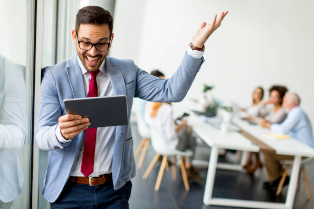 istock Young businessman with digital tablet in office 973301436
