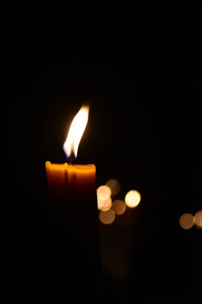 istock Candles Burning at Night and bokeh background 973302100
