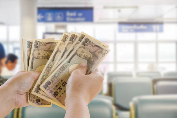 yen banknotes in hand that are ready for travel tourism on blurred background, tourist business idea - lpn imagens e fotografias de stock