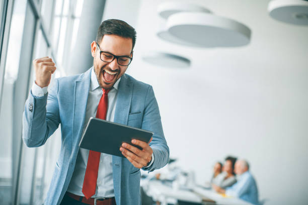istock Young businessman with digital tablet in office 973304876