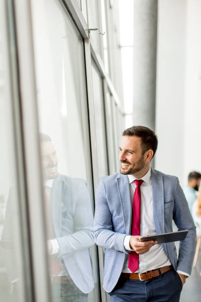 istock Young businessman with digital tablet in office 973304944