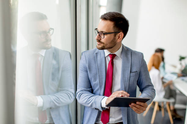 istock Young businessman with digital tablet in office 973304962