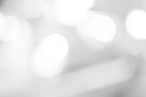 istock white blurred backdrop of nature, circle white wallpaper, gray bokeh background 973309280
