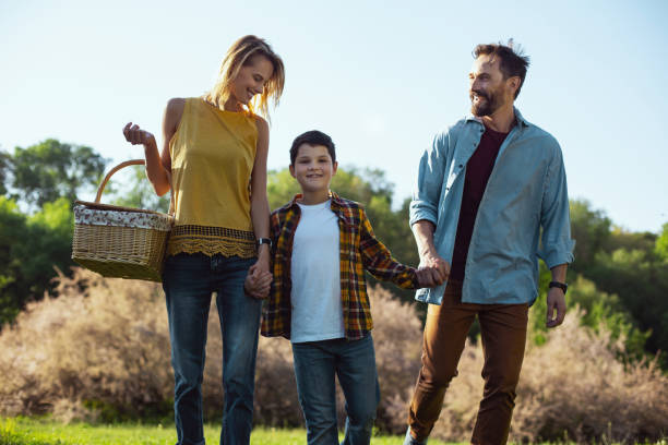 istock Inspired son holding hands with his mom and dad 973314242