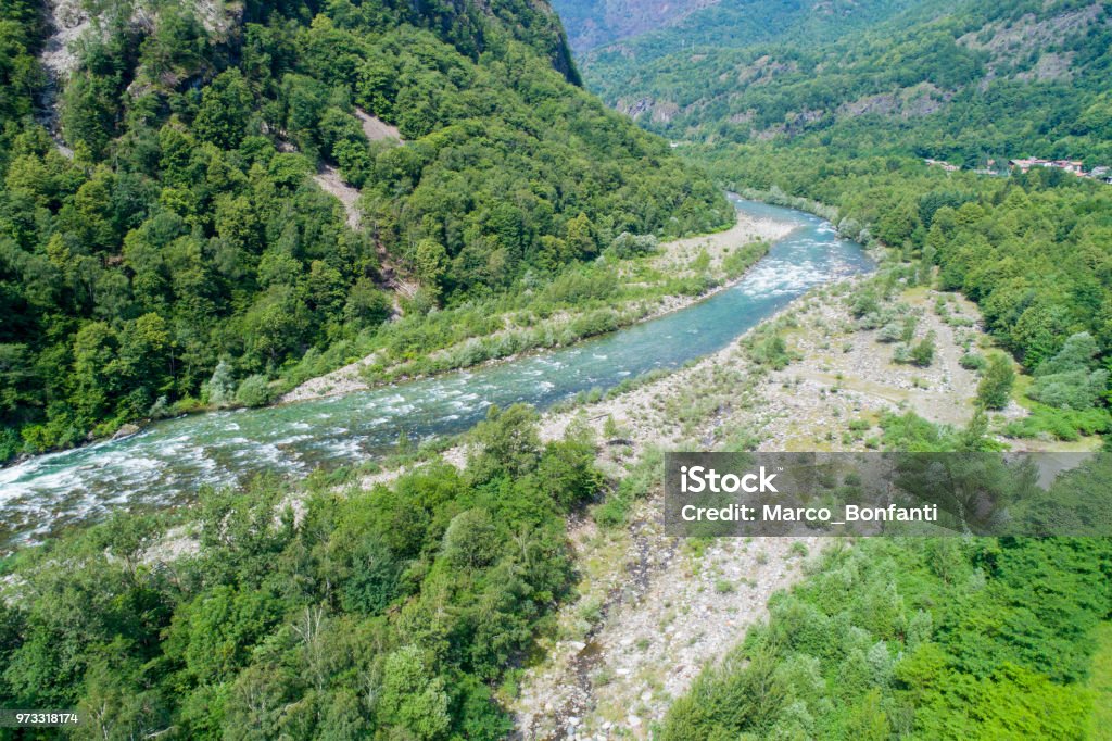 Alpine river Alpine river seen from above. In summer the river gets thicker due to the thaw of the glaciers. Top view of the river Sesia in Piedmont, Italy. Above Stock Photo