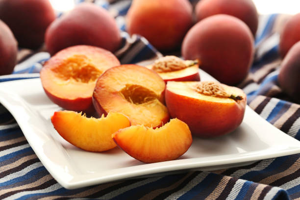 istock Ripe and sweet nectarines fruit in white plate 973318208