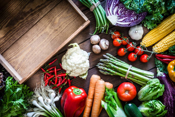 istock Empty wooden crate and vegetables 973318322
