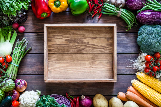 istock Empty wooden crate and vegetables 973318326