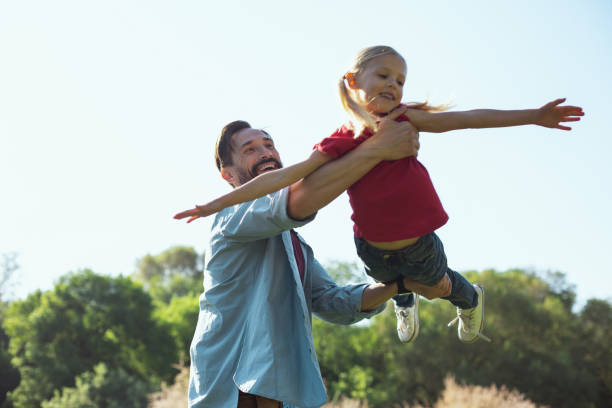 istock Loving daddy playing with his daughter outdoors 973318592