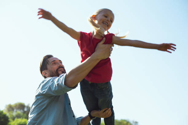istock Caring daddy playing with his daughter outdoors 973318644