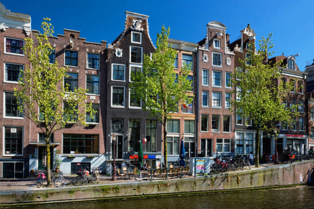 Amsterdam Red-lights district De Wallen AMSTERDAM, NETHERLANDS - MAY 8, 2017: Amsterdam Red-lights district De Wallen. It is the largest and best known red-light district in Amsterdam and popular tourist attraction wellen stock pictures, royalty-free photos & images