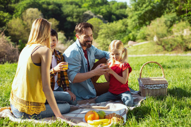 istock Inspired parents having picnic with their kids 973325070