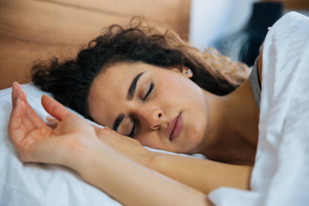 istock Beautiful  young woman sleeping in bed. 973325926