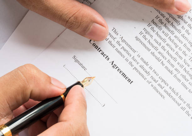 istock contract agreement document for sign with pen 973326044