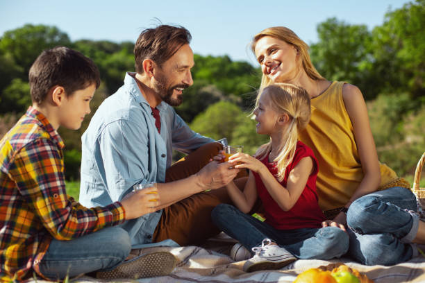 istock Exuberant parents having picnic with their kids 973326220