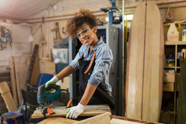 istock Young woman doing woodwork in a workshop 973328858