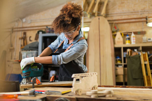 istock Young woman doing woodwork in a workshop 973329088