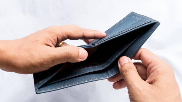 istock Wallet empty and no money hold in his hand 973329120