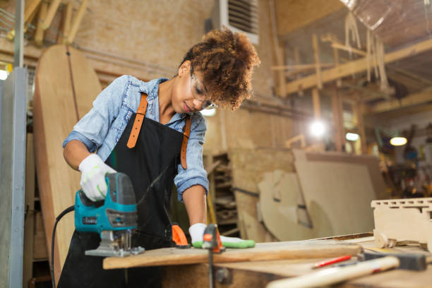 istock Young woman doing woodwork in a workshop 973329138
