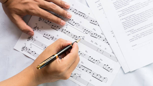 istock song composer working on music note paper 973332752