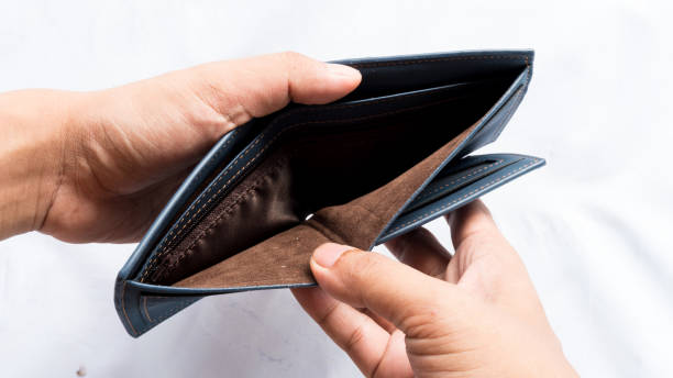 istock Wallet empty and no money hold in his hand 973332950