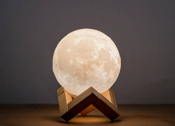 Moon bedside lamp in a wooden stand stock photo
