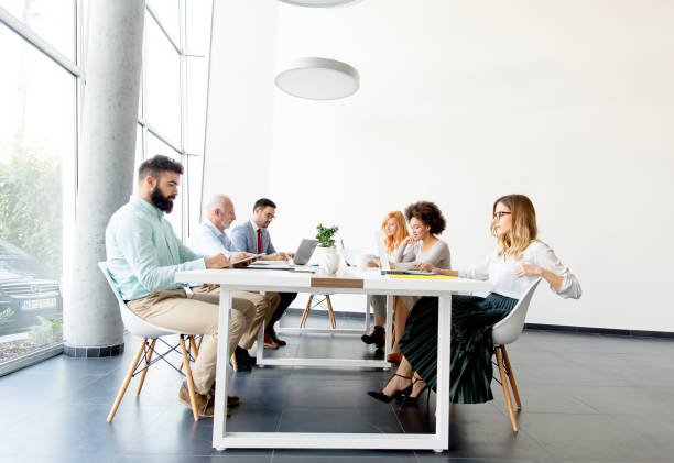 istock Business people around table during staff meeting 973334360