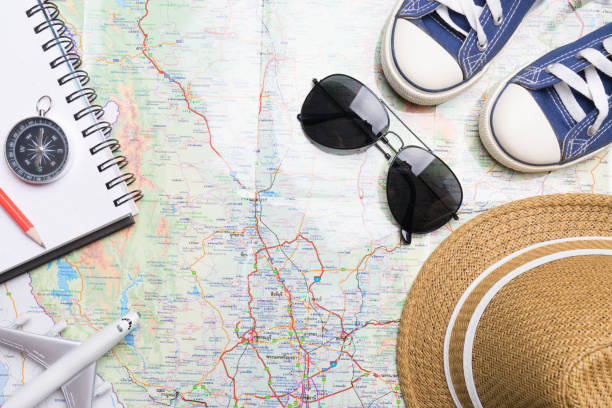istock travel trip accessories  items travel concept on map background 973334618