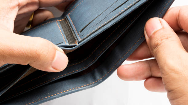 istock Wallet empty and no money hold in his hand 973334812