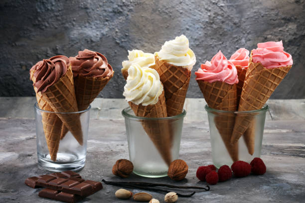 istock Vanilla frozen yogurt or soft ice cream in waffle cone 973338176