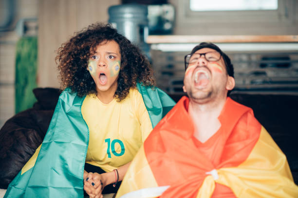 istock Couple watching soccer and shouting in excitement 973338582