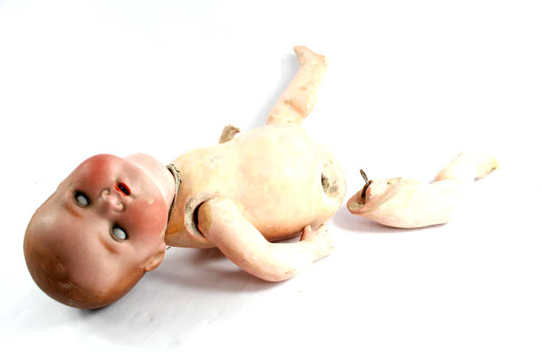 istock Broken Dolly Face and Limbs Scary Halloween Doll On White Background 973338708