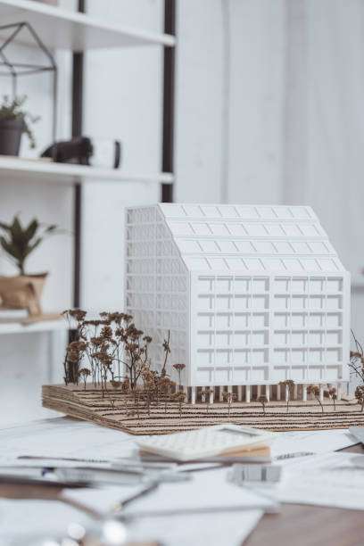 istock close up view of building model at workplace in office 973338794