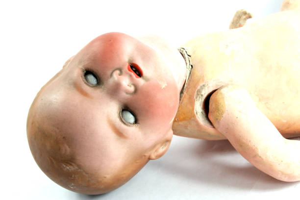 istock Broken Dolly Face and Limbs Scary Halloween Doll On White Background 973339220