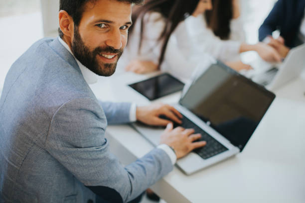 istock Modern businessman with laptop 973339248