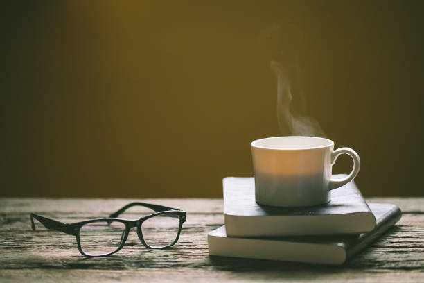istock cup of coffee on book and wooden table 973342408