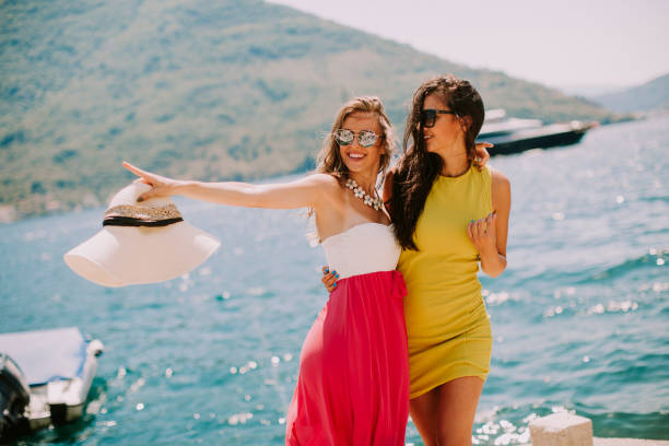 istock Young women relaxing on sea shore 973343336