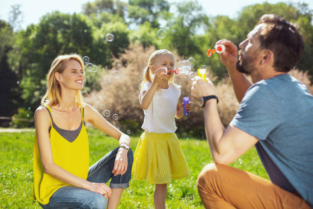 istock Alert parents blowing bubbles with their daughter 973347674