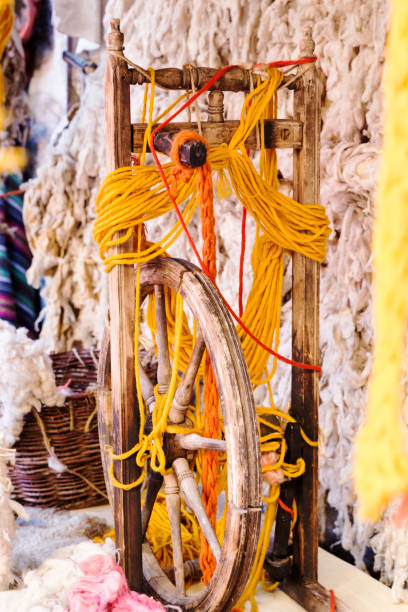 istock old wooden spinning wheel 973351140