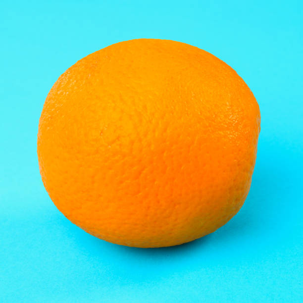 istock Orange whole orange on pastel blue background. 973351278
