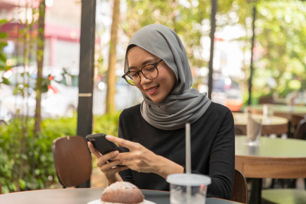 istock Young woman using smart phone 973366864