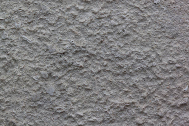 istock Gray plastered handmade rough wallpaper. Beautiful decorative gray plastered wall. 973370280