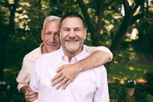 portrait of a loving middle-aged gay couple stock photo
