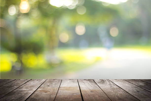 istock empty wooden on blurred nature backdrop. Wood table top. can used for display or montage your products 973371162
