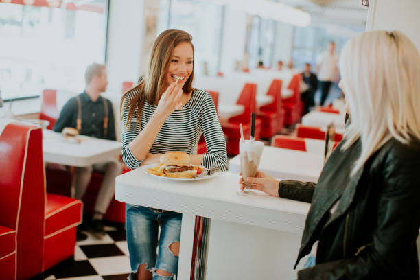 istock Two young women in diner 973373430