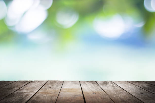 istock empty wooden on blurred nature backdrop. Wood table top. can used for display or montage your products 973373810