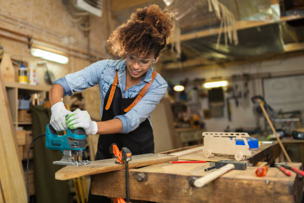 istock Young woman doing woodwork in a workshop 973374366